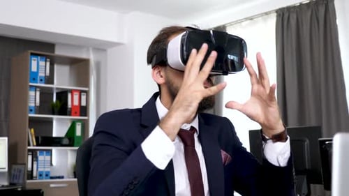 Businessman Using VR Headset at Office Desk