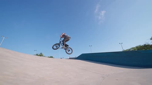 Young Adult Doing BMX Stunts at Skate Park