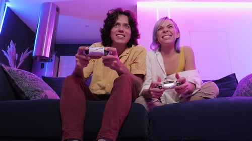 Excited Couple Plays Video Games on Couch