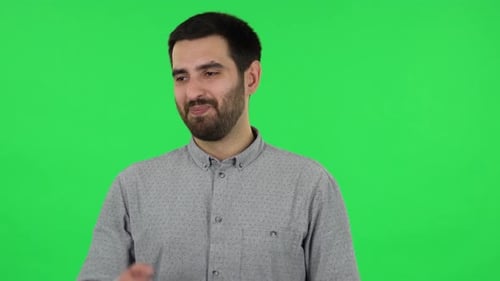 Portrait of Brunette Guy Is Looking at Camera with Anticipation, Then Very Upset. Green Screen