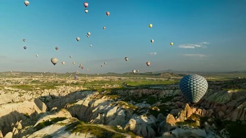 4K Aerial view of Goreme. Colorful hot air balloons fly over the valleys.