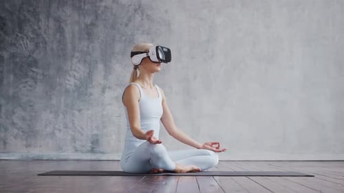 Blonde Woman Meditating with VR Headset
