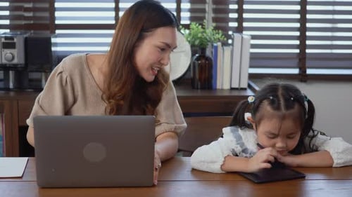 Woman and Child Work at Desk