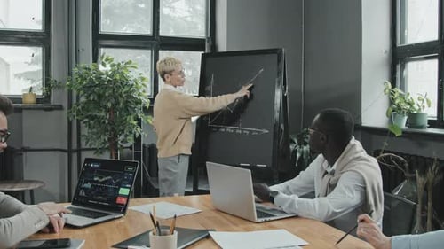 Business Team Analyzes Financial Charts in Office