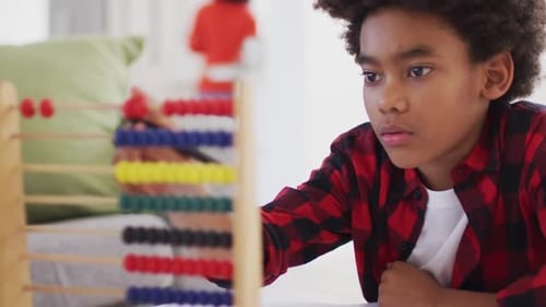 Boy using abacus at home