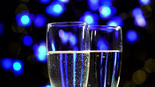 Champagne glasses with blue lights background