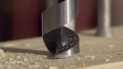 Drill Bit Creating Hole in Wood Close Up