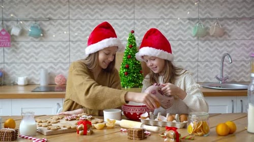 Girls Baking Christmas Cookies in Kitchen