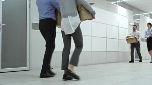 Businessman and Businesswoman Moving in New Office