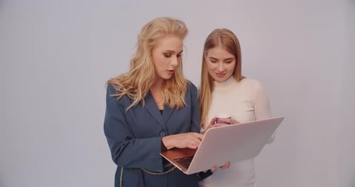 Two Young Women Looking at Laptop Screen