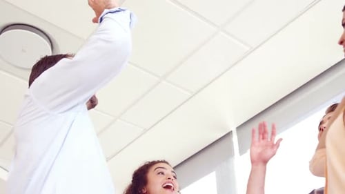Teamwork High Five Celebration in Office