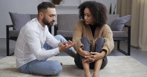 Couple Discussing Relationship Issues in Living Room