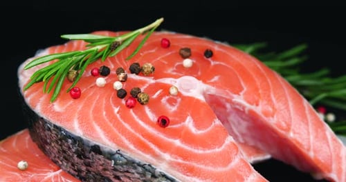 Close up of Salmon Steak with Rosemary and Pepper