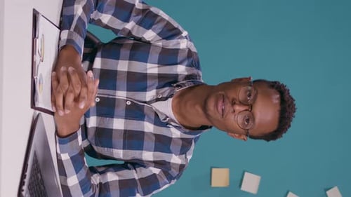 Young Adult Explains Data in a Vertical Office Video