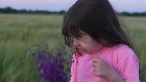 Pollen allergy. Little girl sneezes from flowers.