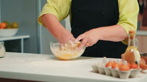 Adult Hands Mixing Dough in Bowl at Home