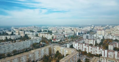 Aerial drone footage of city from above during autumn in a cloudy day.