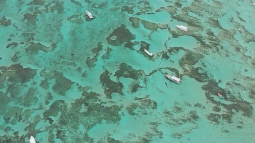 Sea Reefs Off the Coast of the Village of Lembongan with Boats on the Island of Nusa Lembongan
