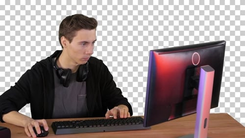 Gamer playing a video game on personal computer, Alpha Channel