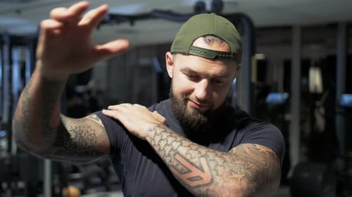 Athletic Man Stretching Shoulders Before Workout