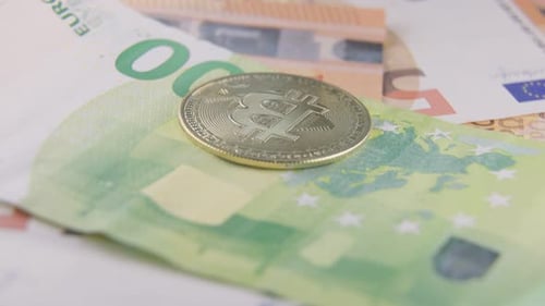 Shiny Bitcoin on Euro Banknotes Close Up