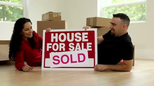Happy Couple Celebrating Home Purchase Success Together