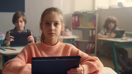 Student Browsing Internet Online on Digital Tablet During Lesson at School