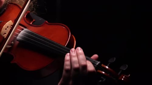 Violinist Playing the Violin in Dark Room