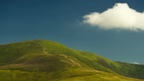 Time Lapse Clouds Move over Mountain Hill in Green Valley