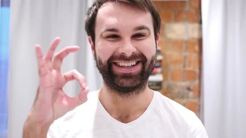 Young Adult Giving Okay Sign Close Up