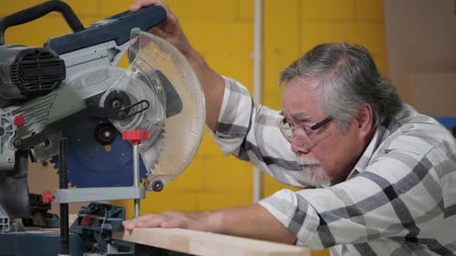 Man Using Chop Saw for Woodworking Project