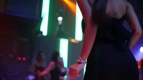 Young people are having fun dancing in club. Nightlife and disco concept.