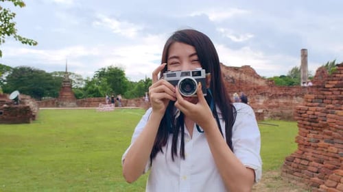 Woman with Camera at Ancient Ruins