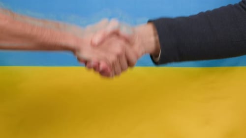 Handshake in Front of the Ukrainian Flag