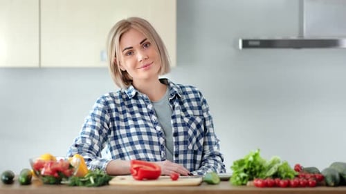 Blonde Woman with Vegetables in Kitchen