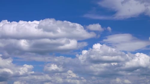 Clouds Floating Peacefully Across Clear Blue Sky