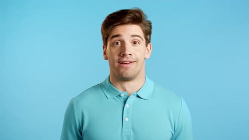 Surprised Man with Mouth Open on Blue Background