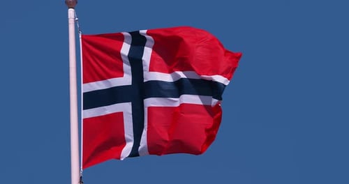 Norwegian Flag Waving Against Blue Sky