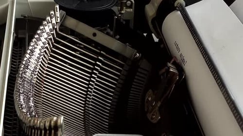 The man is typing on a retro typewriter.