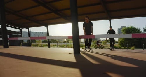 Two Young Guys Ride City on Skateboards