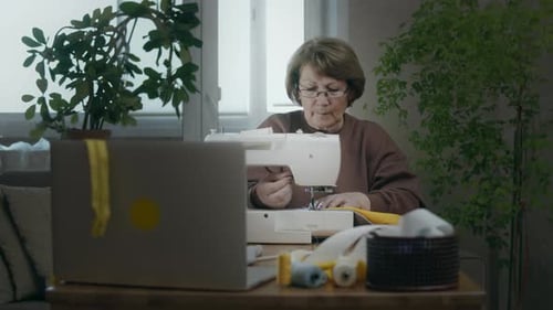 Woman use sewing machine at home