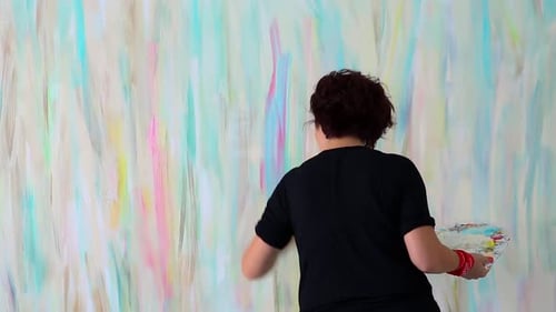Artist Painting Colorful Mural with Brush Indoors