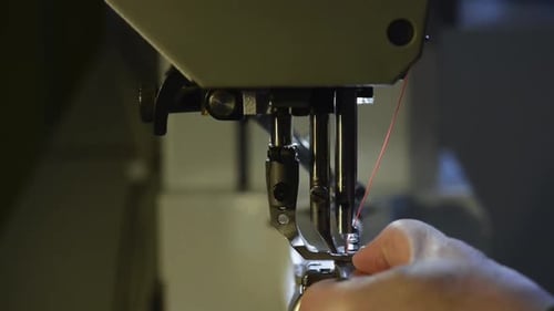 Sewing Machine Needle Seam with Red Thread