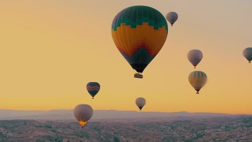 Hot Air Balloons Floating Over Cappadocia Landscape at Sunrise
