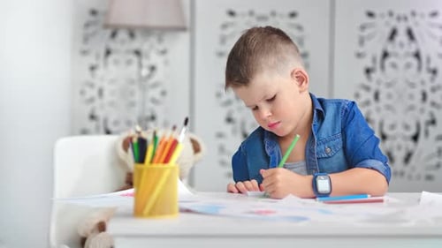 Creative Attractive Male Child Drawing Colorful Picture Paper Enjoying Art at Home