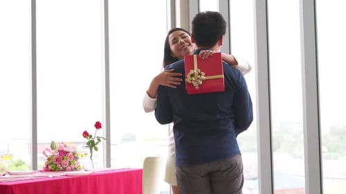 Romantic Couple Giving Gift to Lover at Restaurant