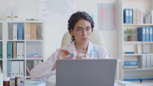 Woman Doctor Telehealth Video Call in Office
