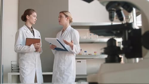 Scientists Discussing Research in a Lab