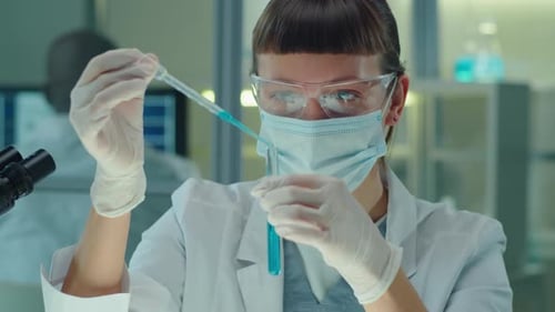 Scientist Working With Pipette and Test Tube