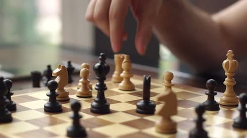 Hand Moving Chess Piece on Game Board